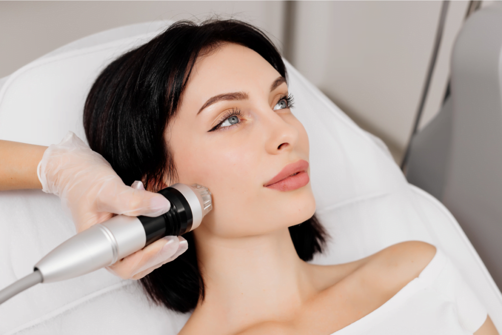 Model receiving treatment with RF microneedling for face in medical spa